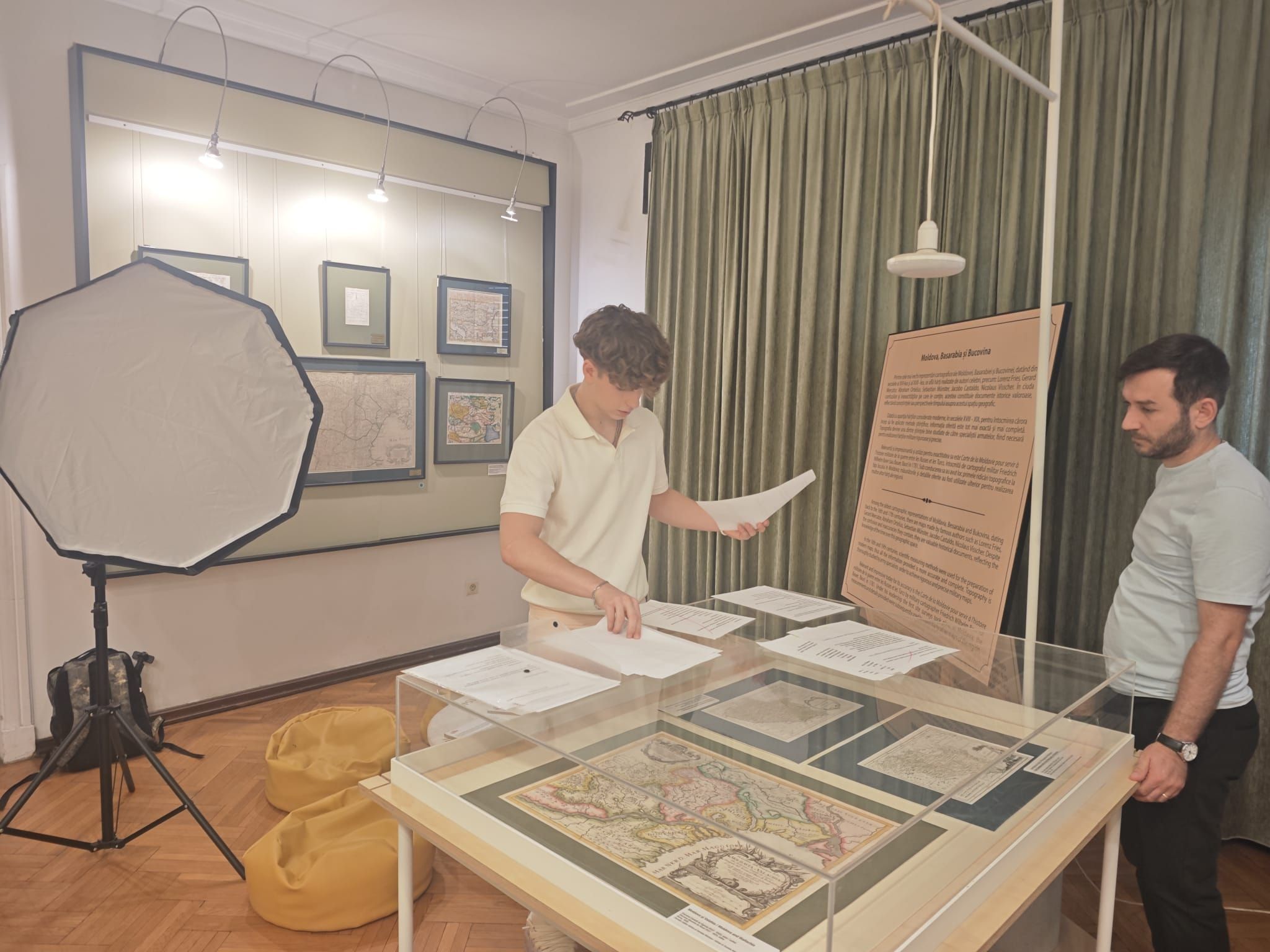 Anton at work at Muzeul Hărților, laying out prints on a map display case
